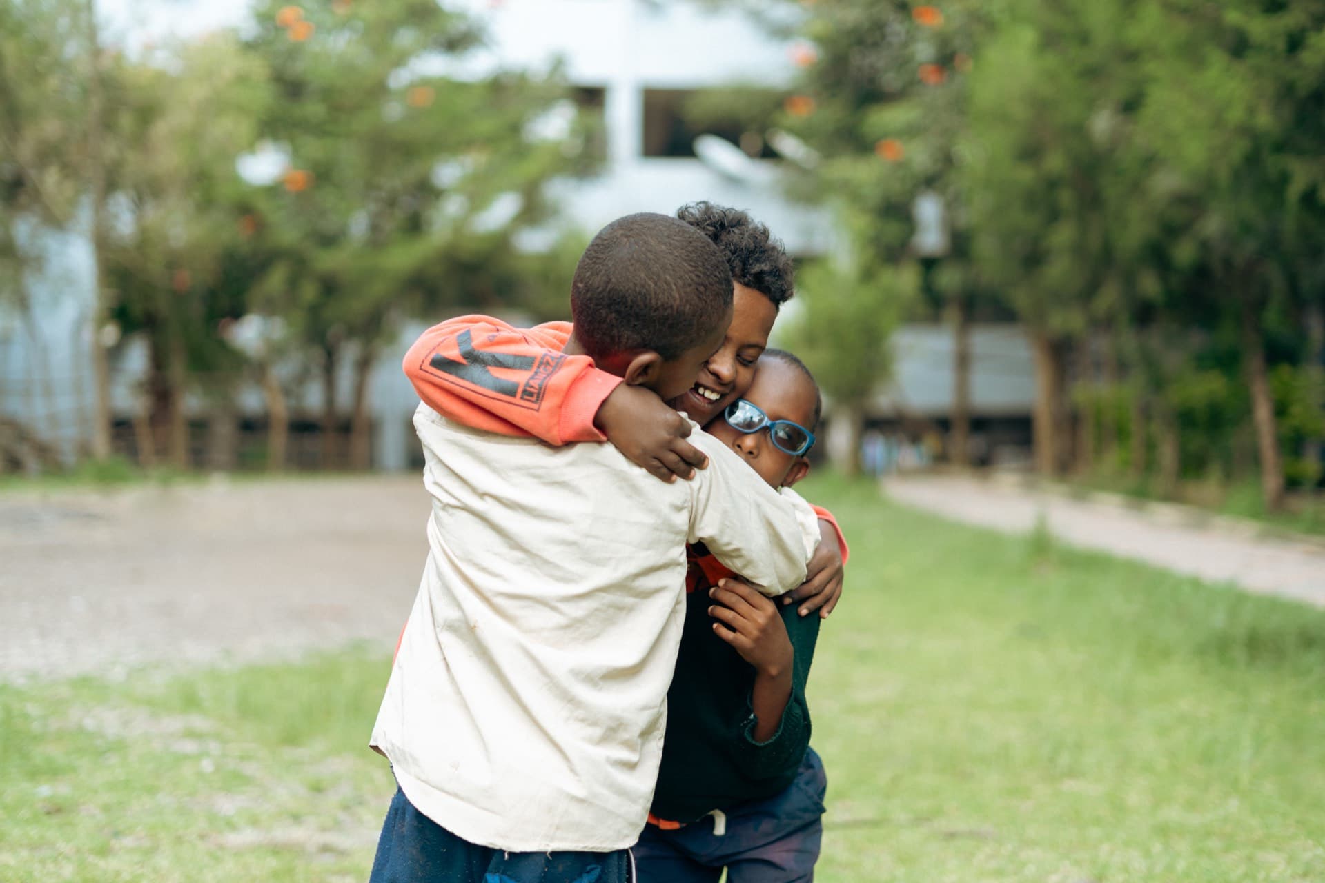 Two kids embracing each other with joy