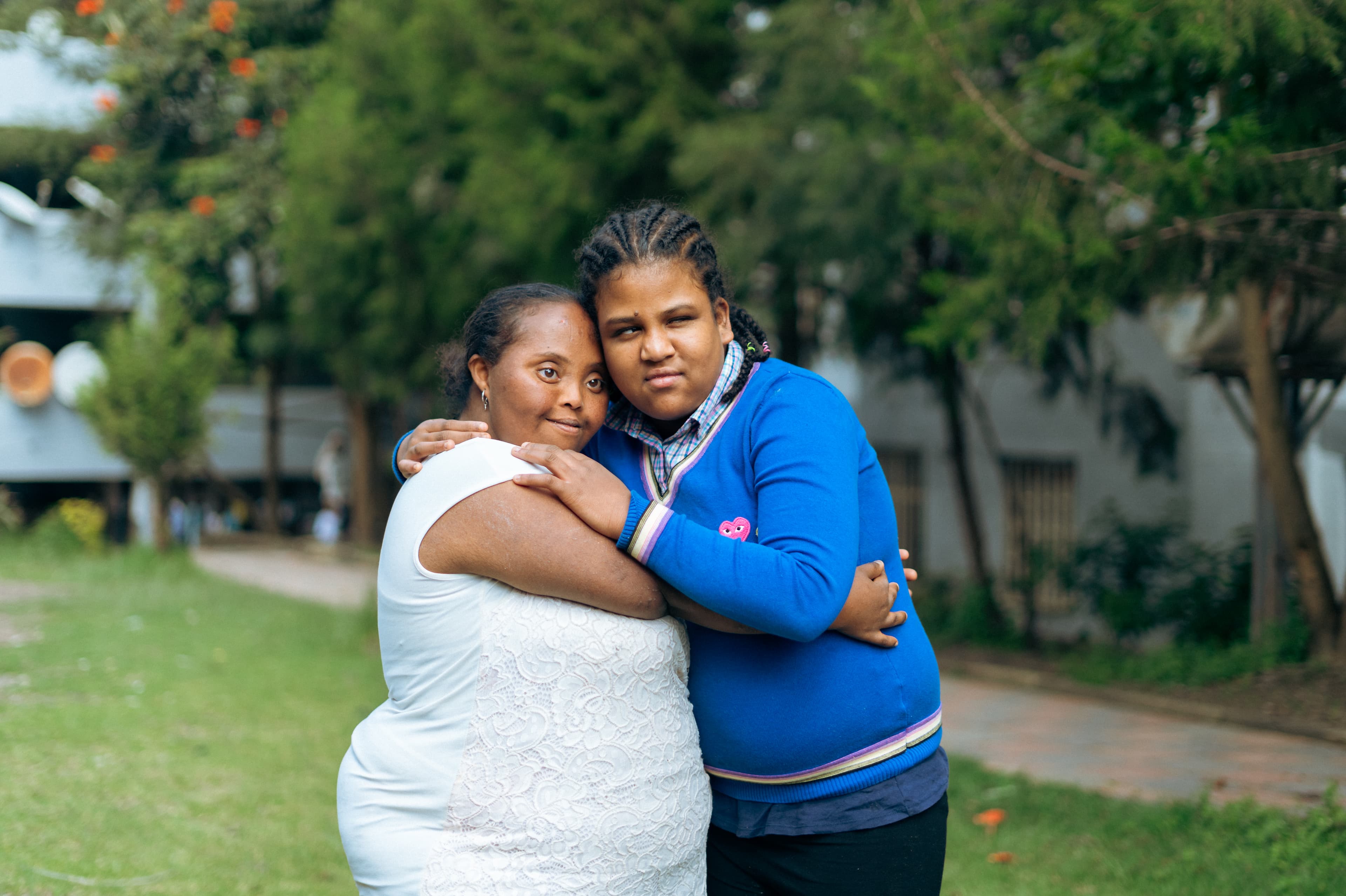 Two girls hugging each other affectionately